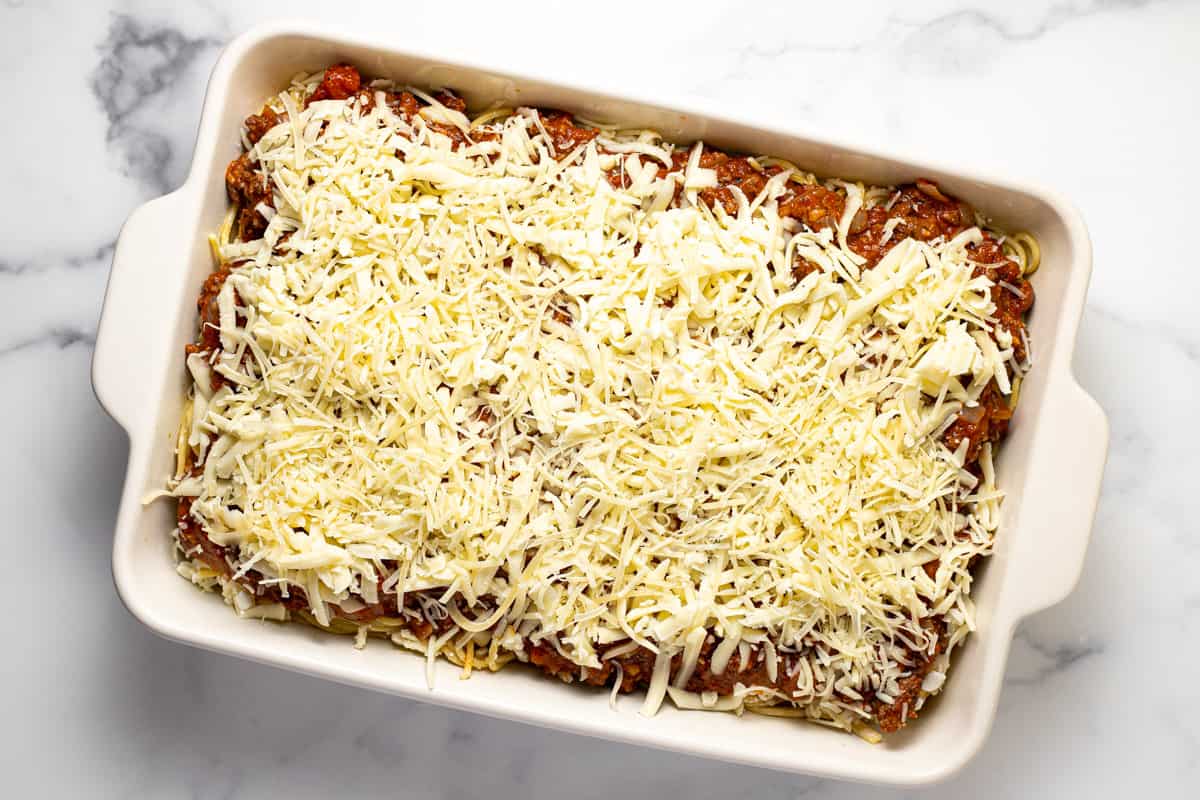 Homemade spaghetti casserole topped with tons of shredded cheese