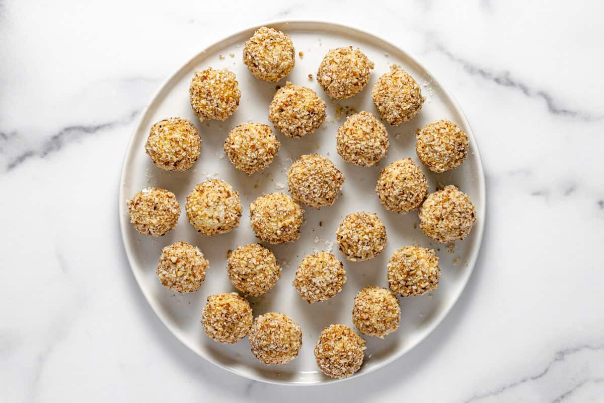 Pecan crusted goat cheese balls on a large round white platter