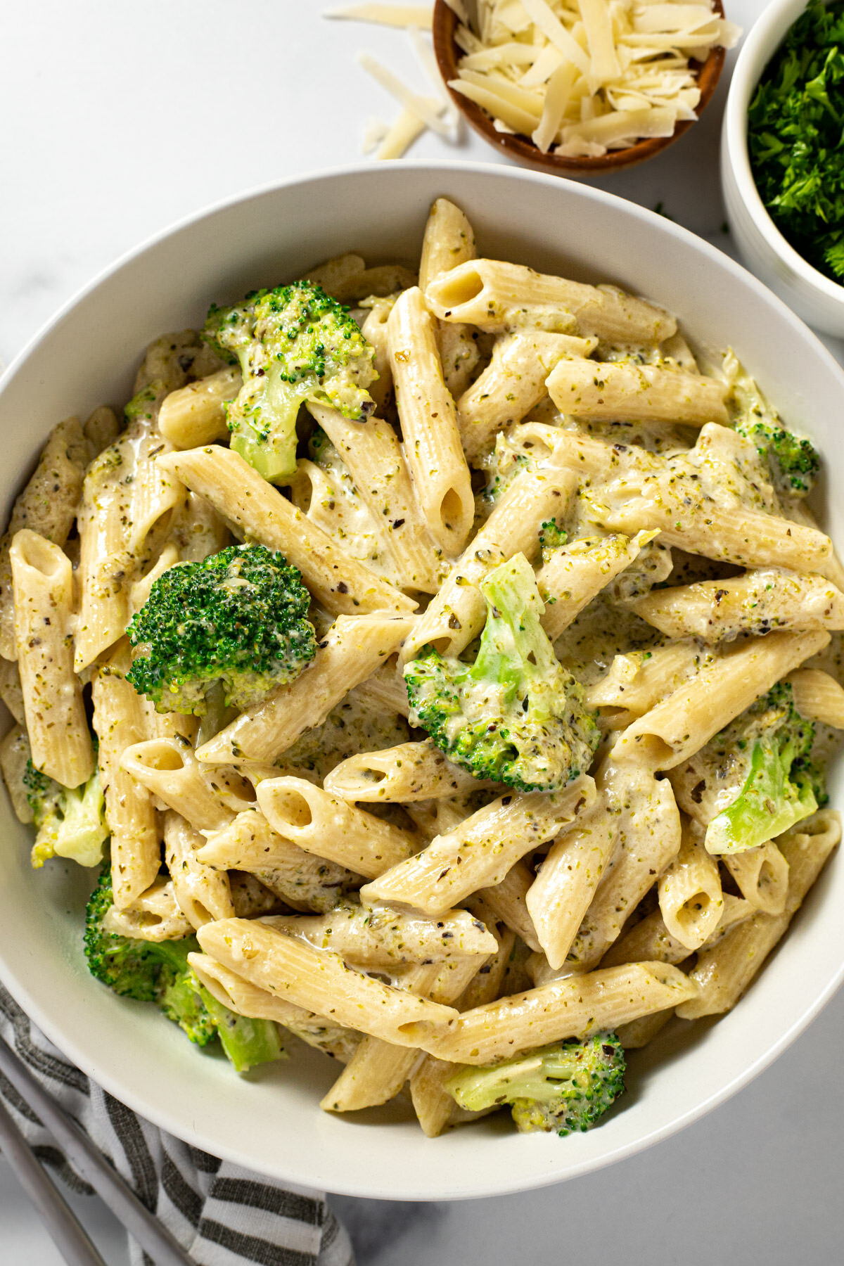 White bowl filled with creamy instant pot pasta and broccoli