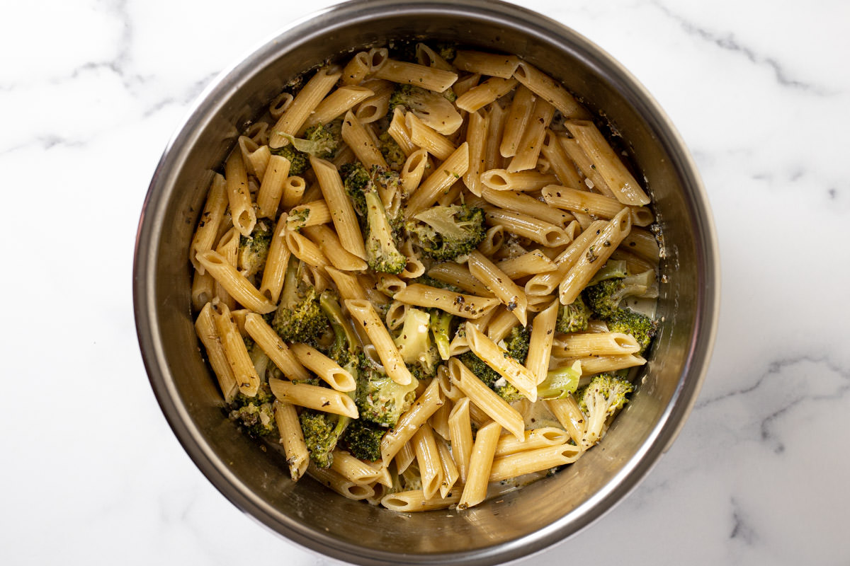 Instant pot insert with ingredients to make instant pot pasta with broccoli