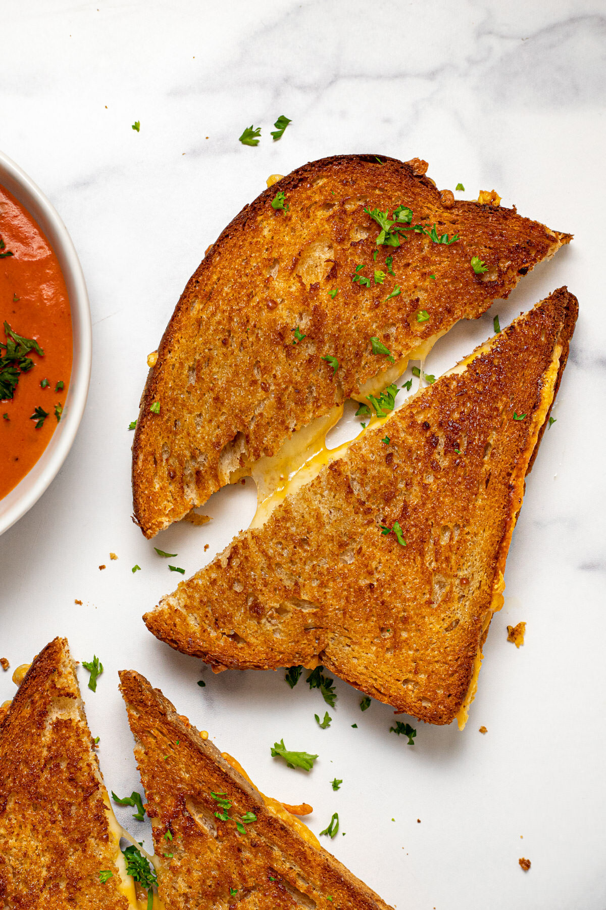 Overhead shot of an air fryer grilled cheese sandwich sliced in half