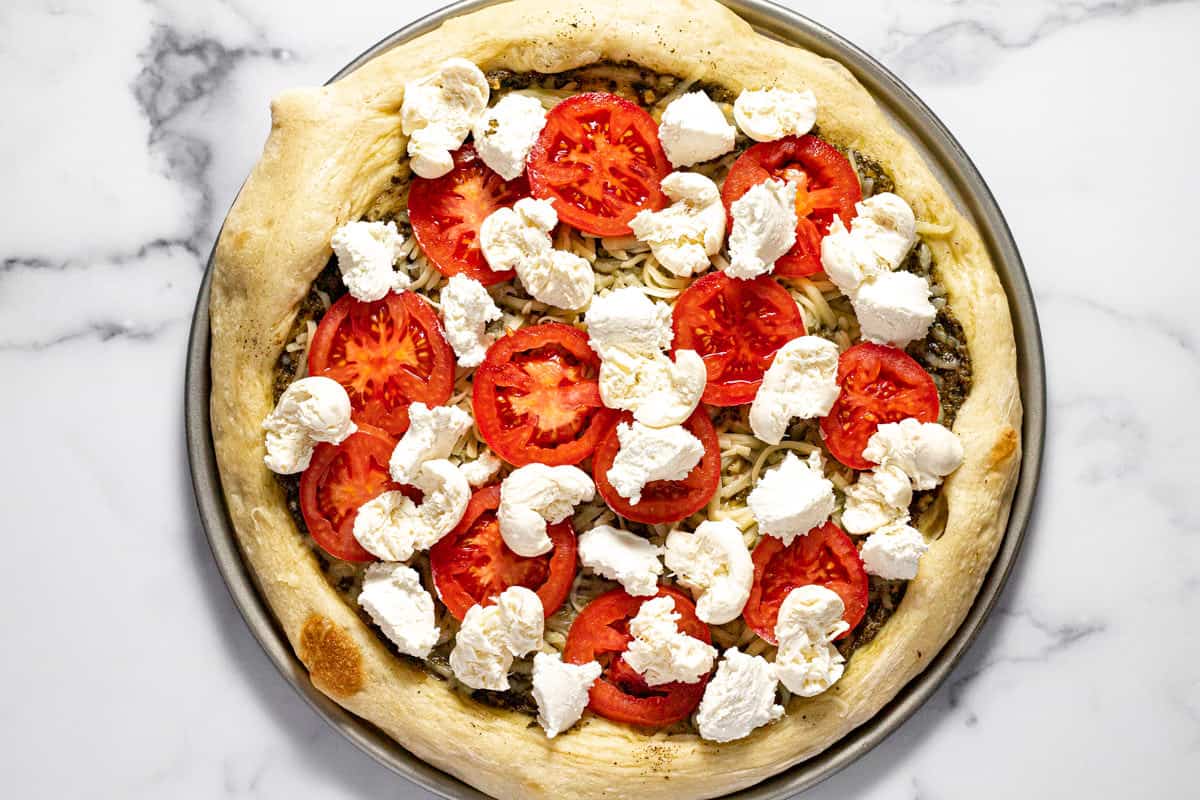 Caprese pizza topped with cheese and tomatoes