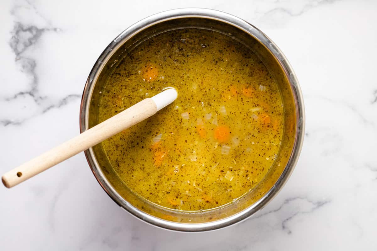 Instant pot insert filled with ingredients to make creamy instant pot soup