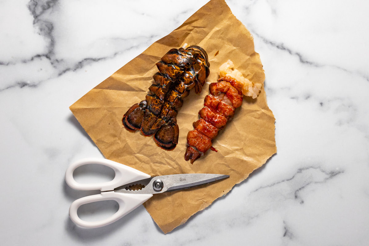 A lobster tail on parchment paper separate from the shell