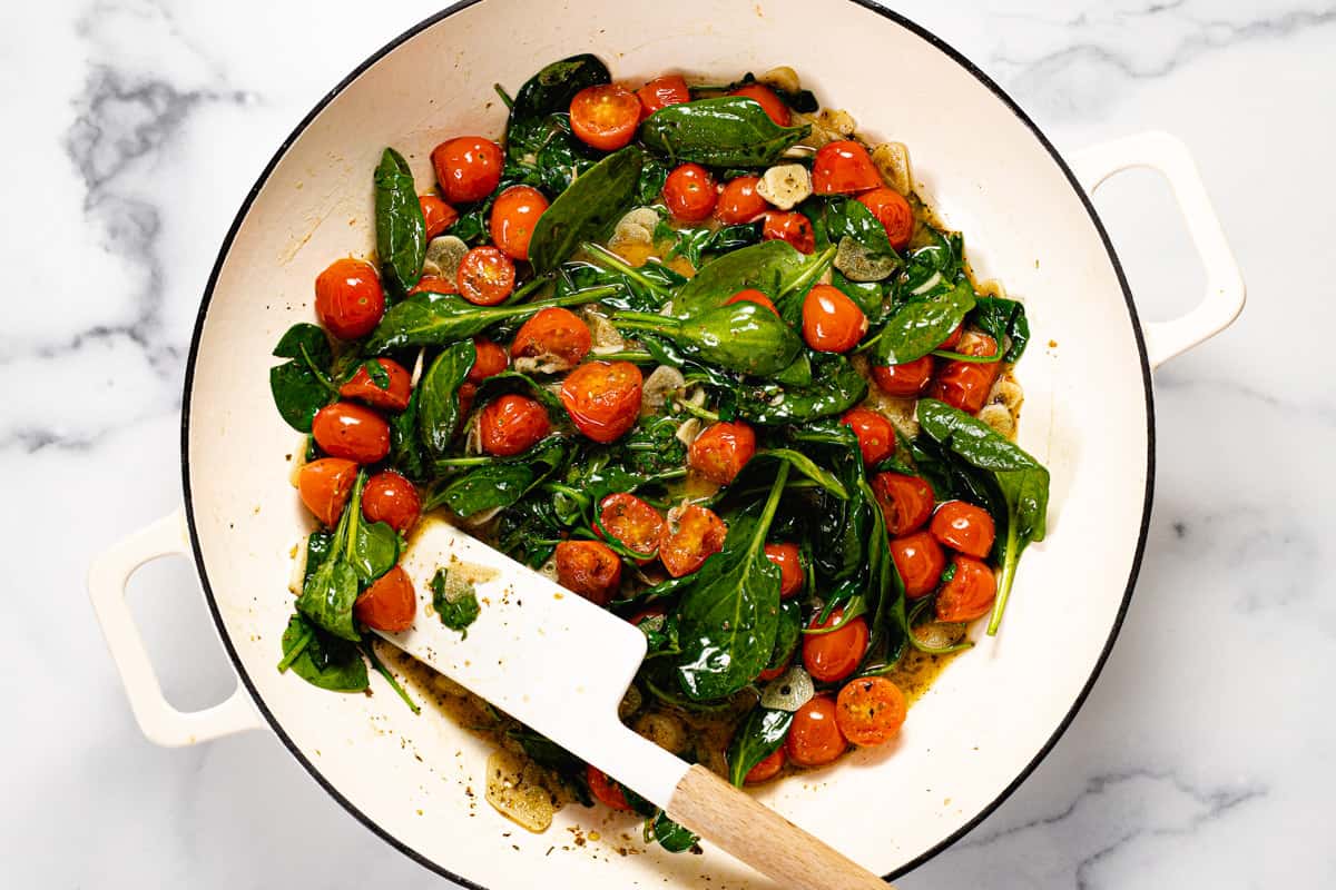 Tomatoes and spinach in a garlic white wine sauce