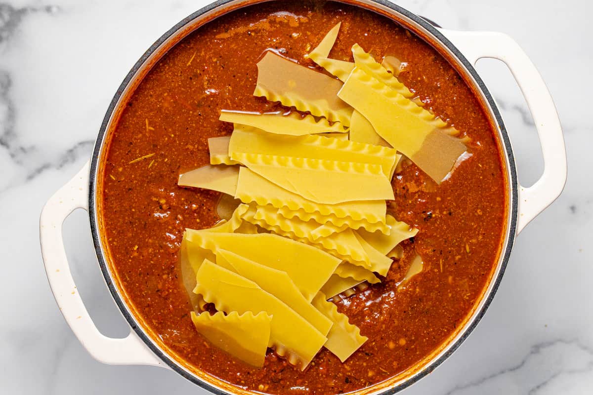 Large pot with ingredients to make lasagna soup