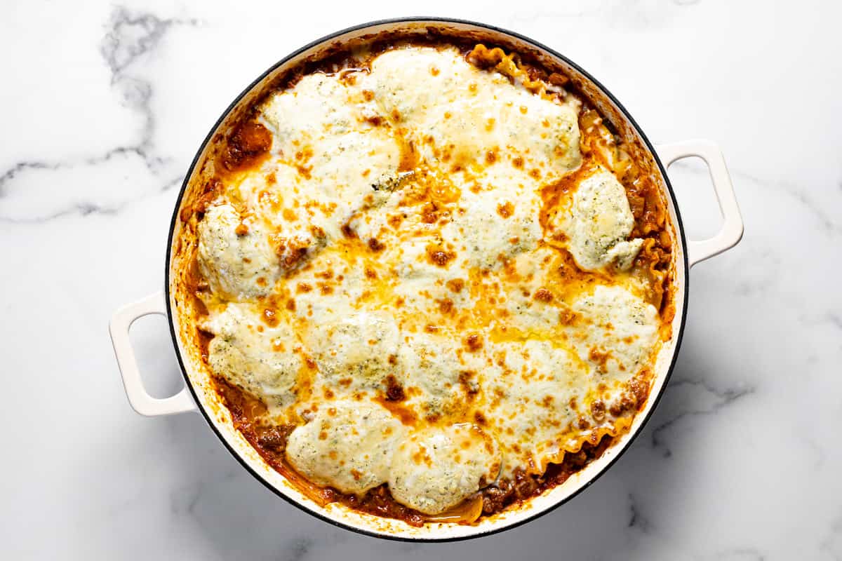 Large white pan filled with homemade skillet lasagna
