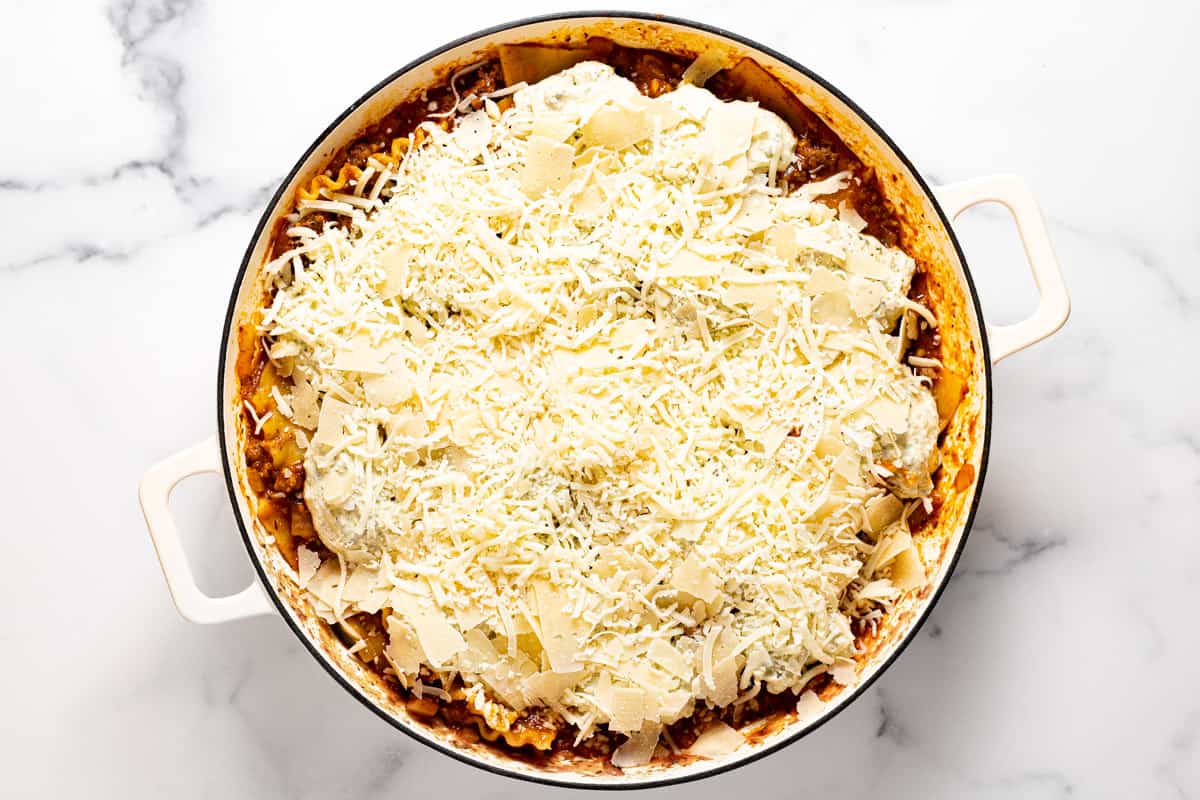 Large white pan filled with ingredients to make skillet lasagna