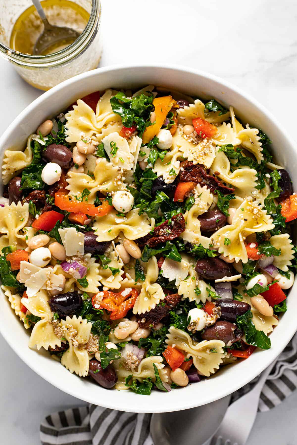 Large white bowl filled with homemade Italian pasta salad
