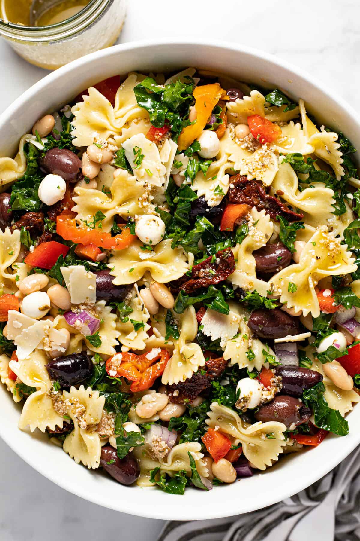 Large white bowl filled with homemade veggie Italian pasta salad