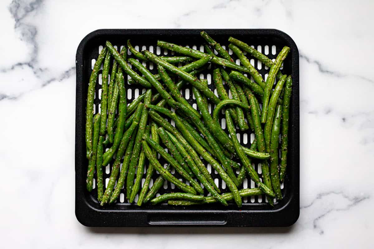 Air fryer tray with cooked green beans