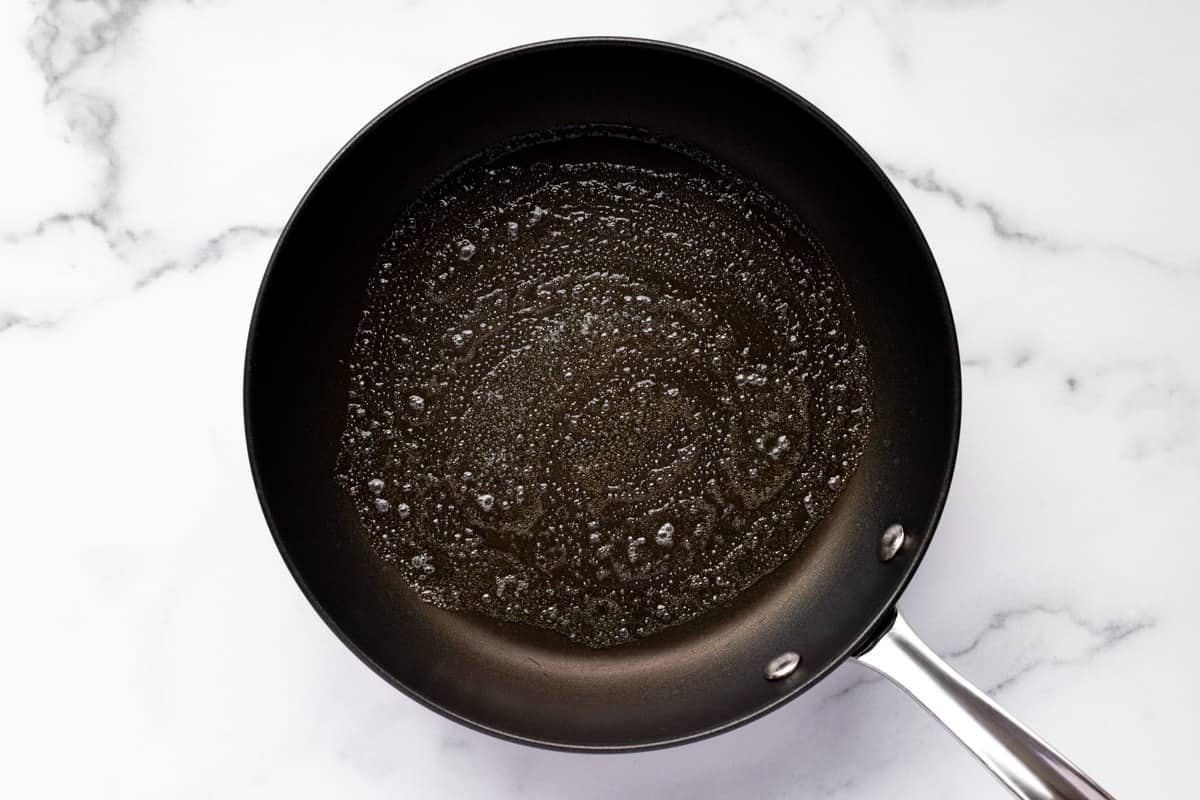 Black skillet with melted butter in it
