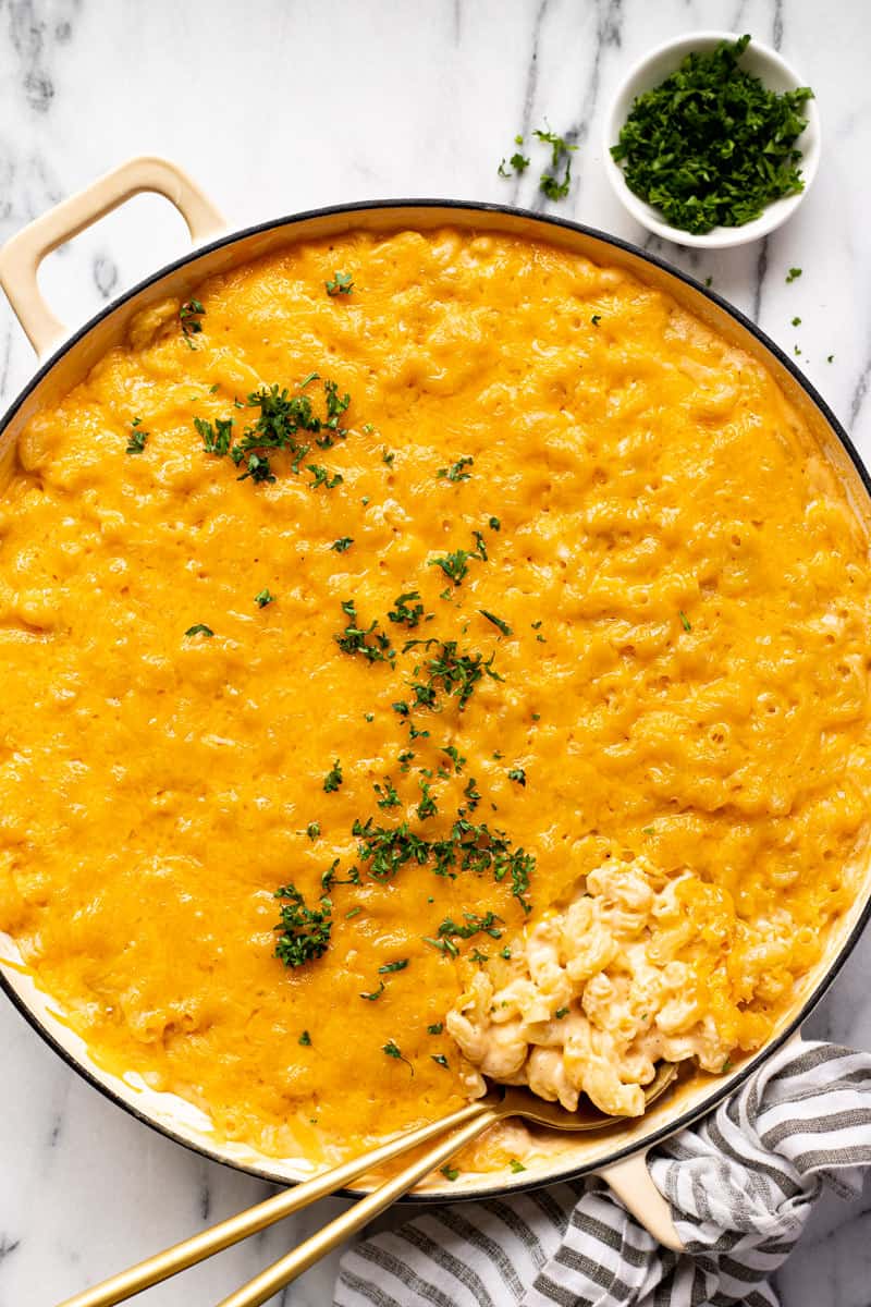 Large white pan filled with creamy homemade smoked mac and cheese garnished with parsley