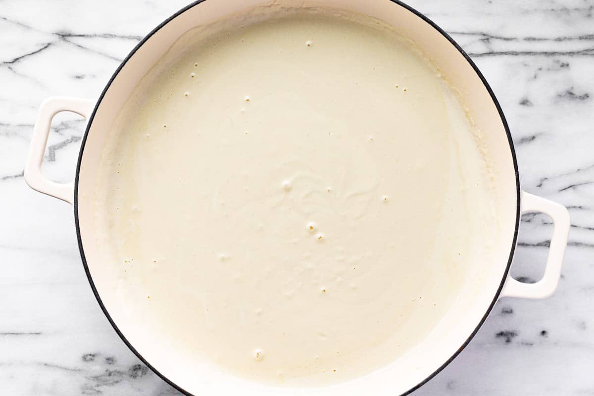 Creamy cheese sauce in a white pan