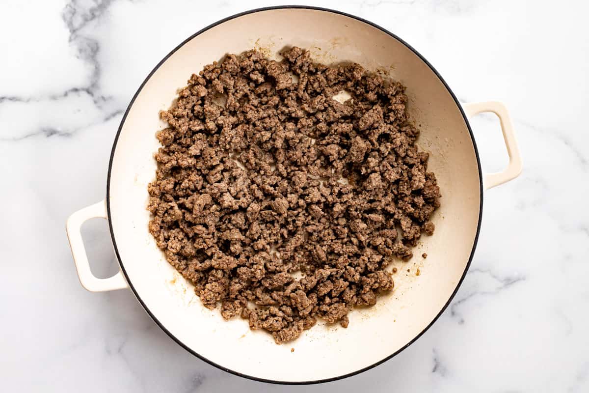 Large white pan filled with browned ground beef