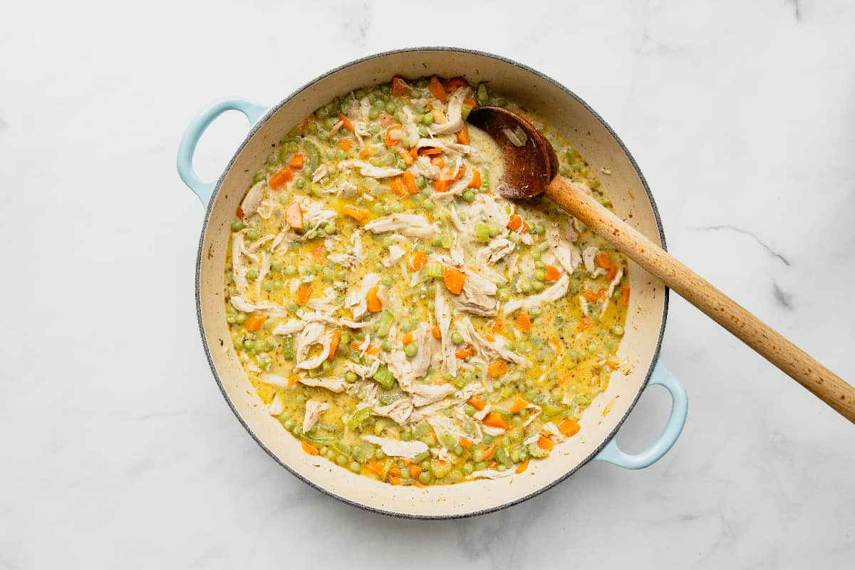 Large pan filled with creamy chicken pot pie filling.