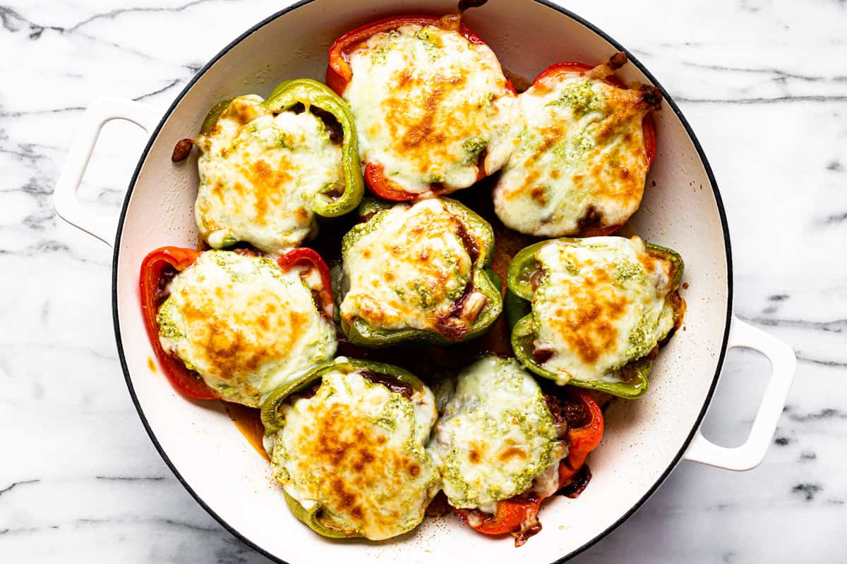 Freshly baked Italian stuffed peppers in a large white pan.