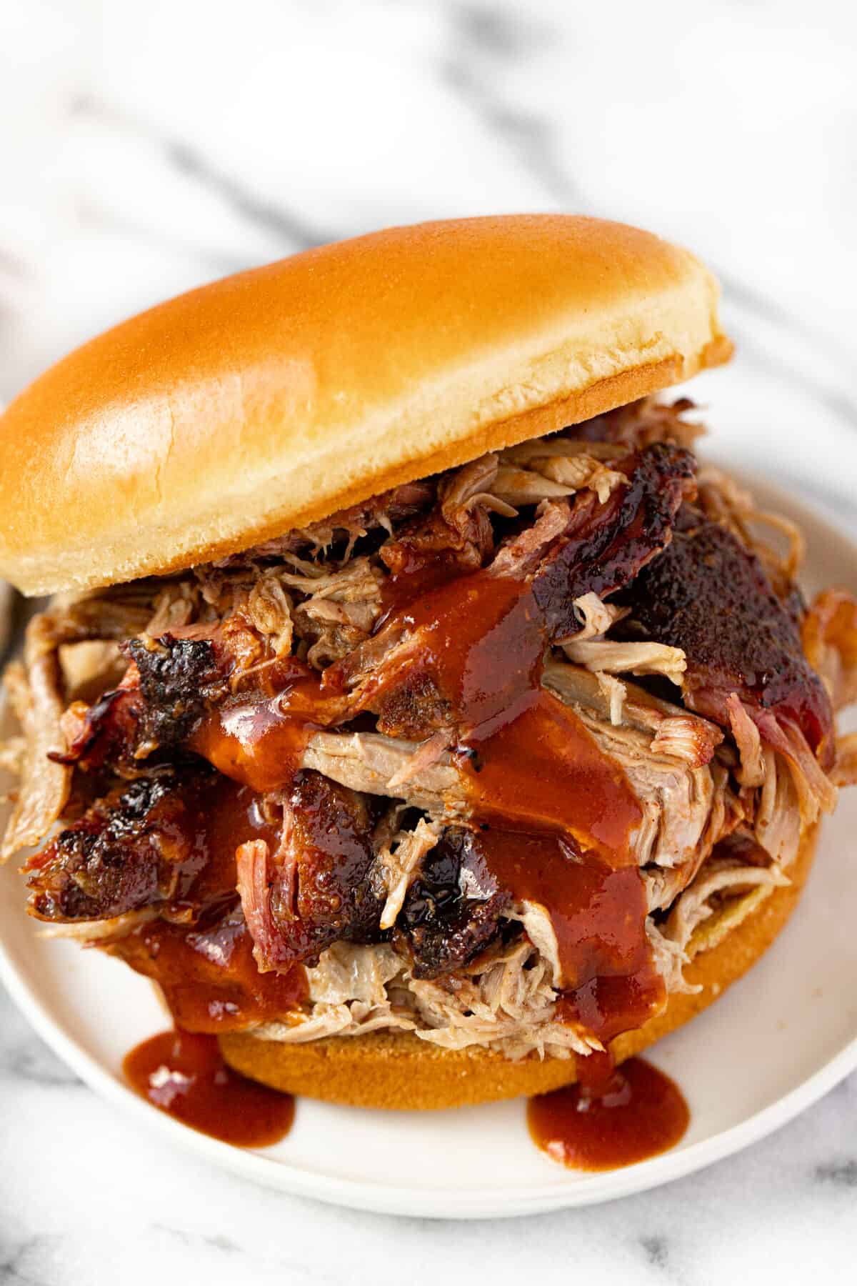 Pulled pork sandwich drizzled with barbecue sauce