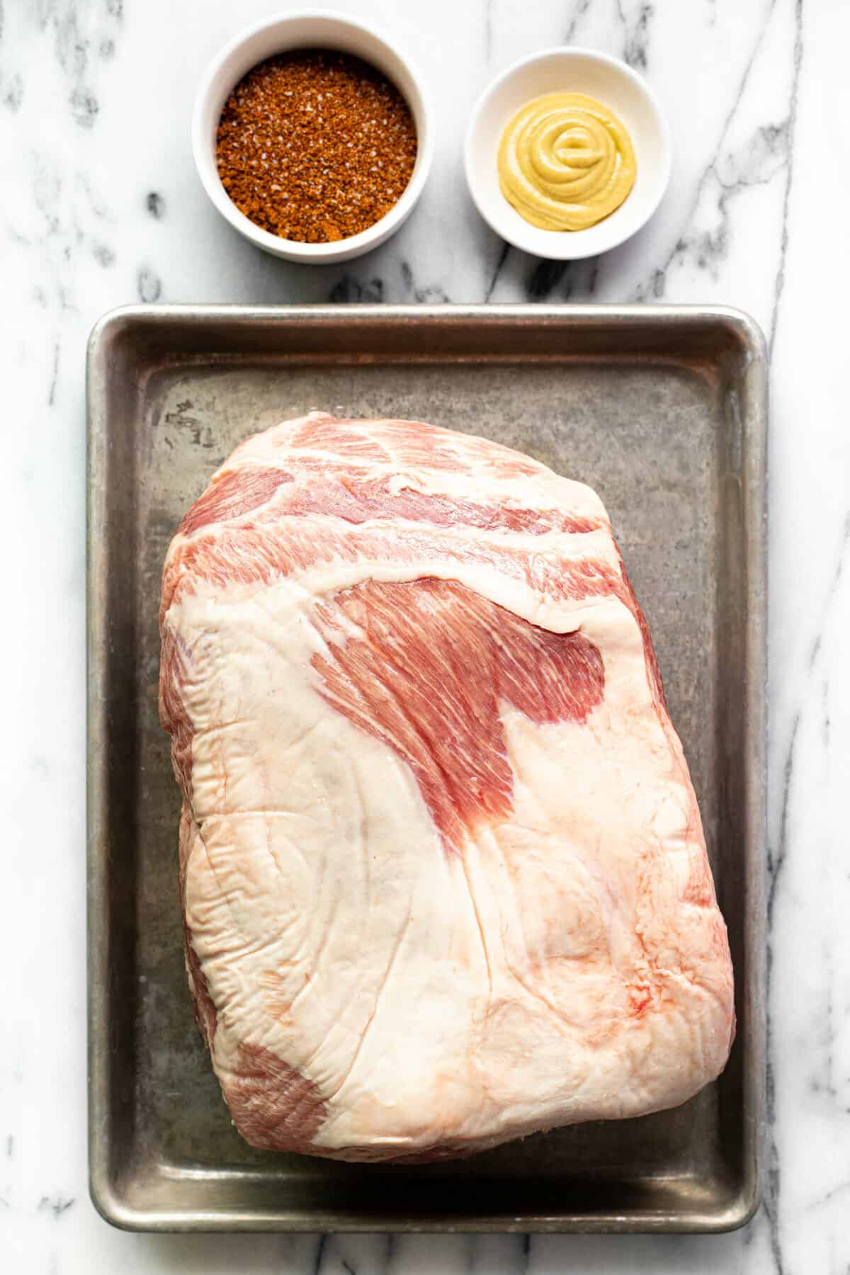 White marble counter top with ingredients to make smoked pork butt