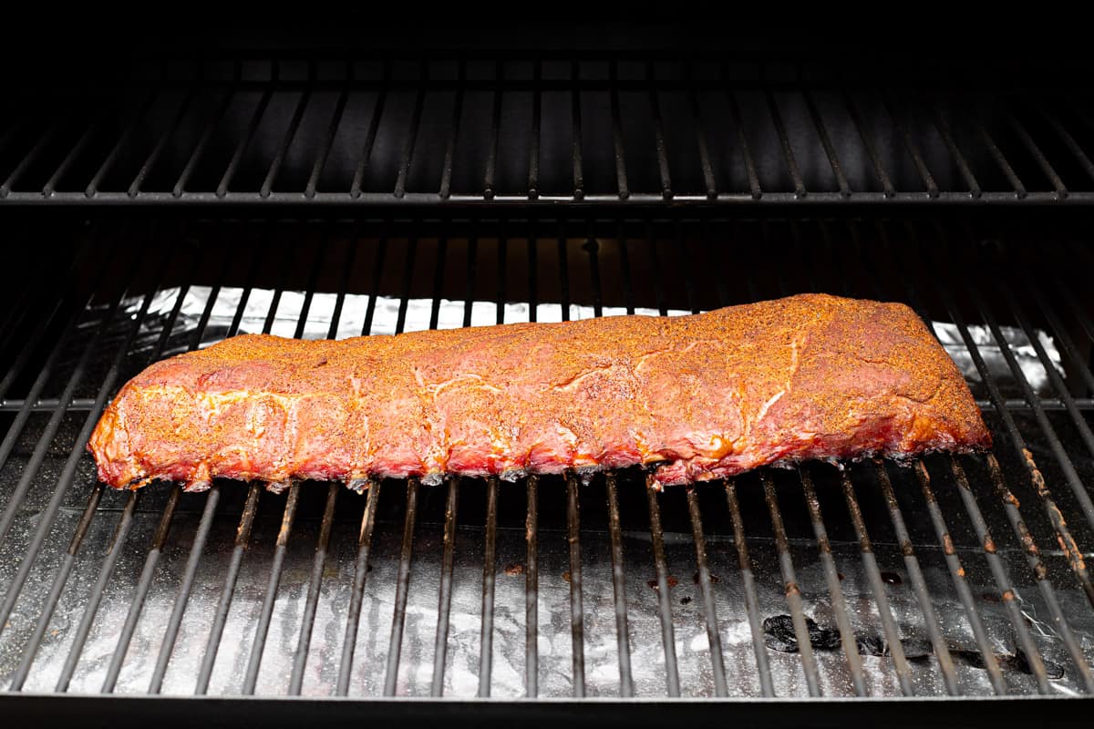 A rack of ribs in a wood pellet grill.