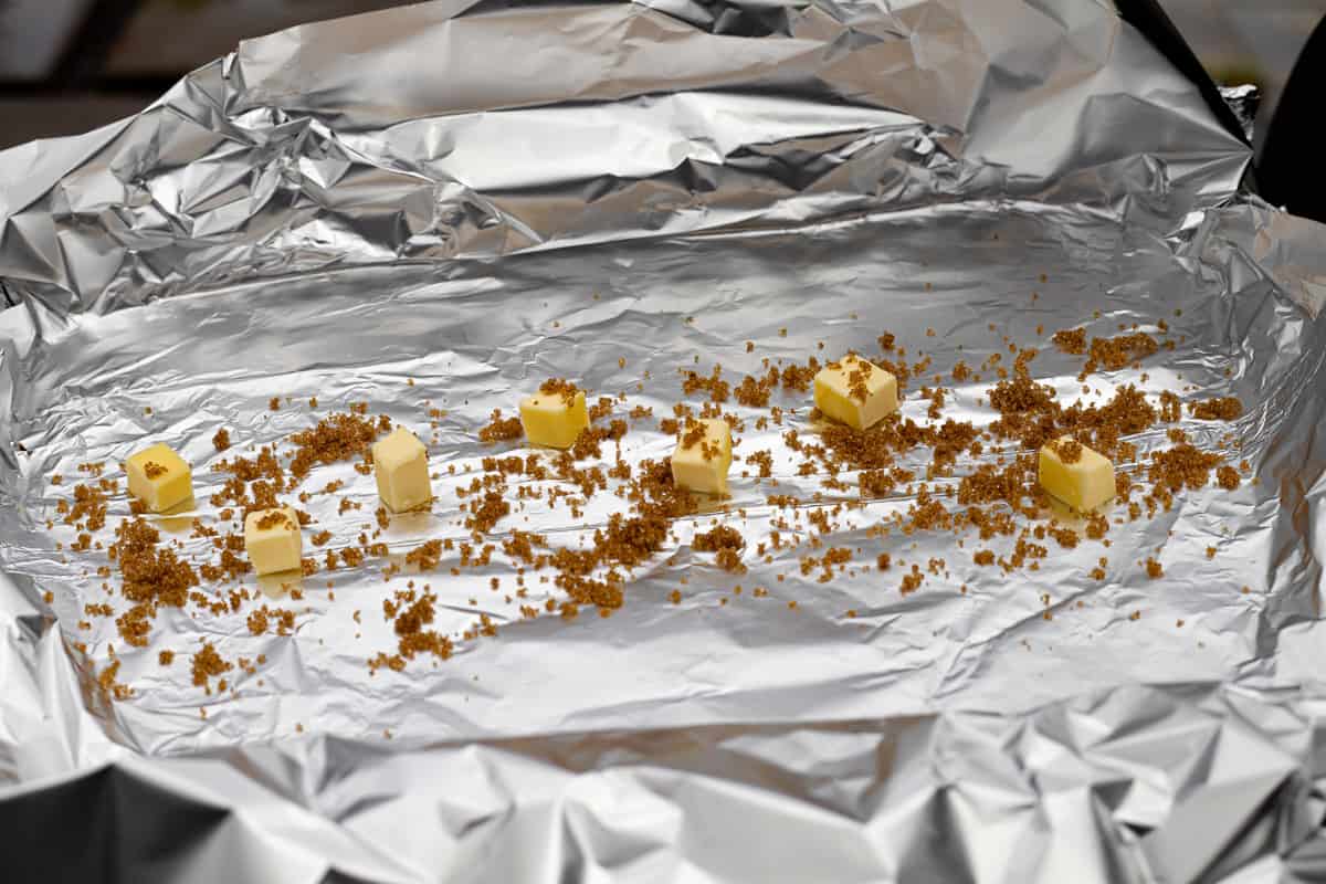 Tin foil with cubes of butter and brown sugar.