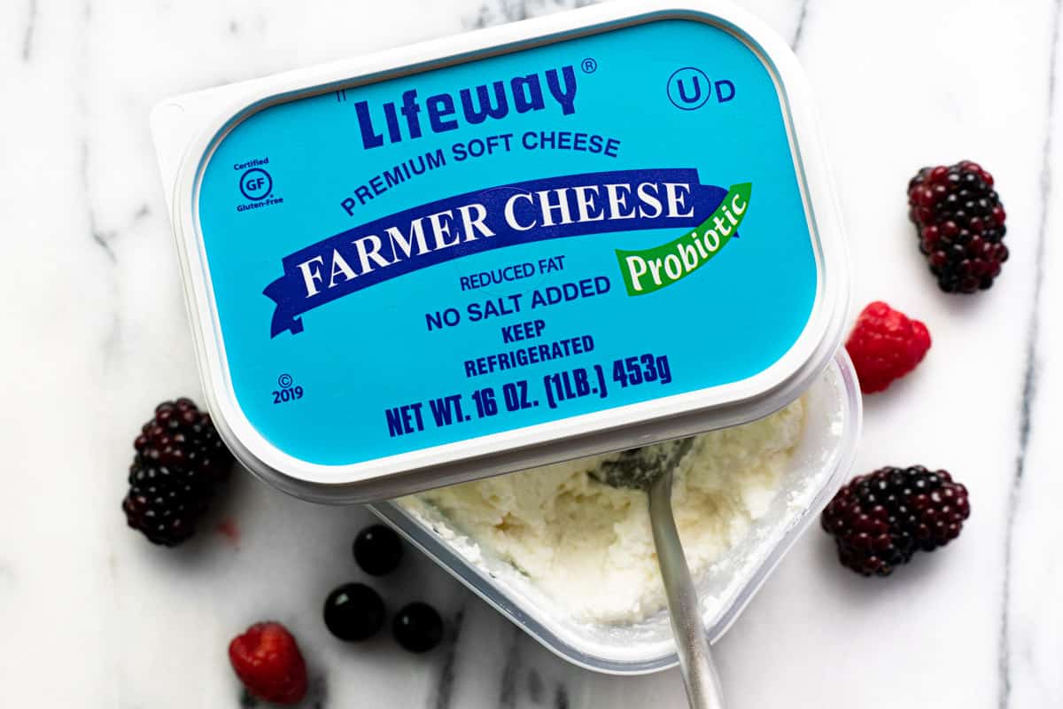 Box of Lifeway farmer cheese with some mixed berries laying around it.