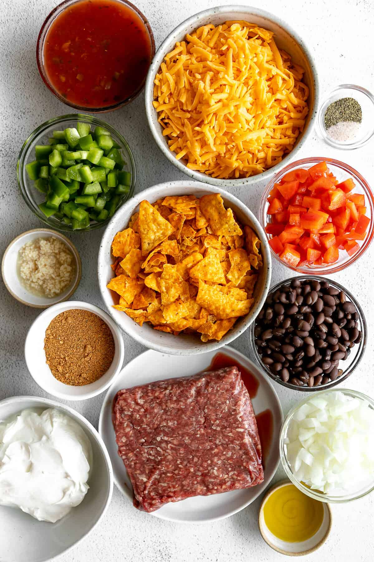 Bowls of ingredients to make easy Dorito casserole.