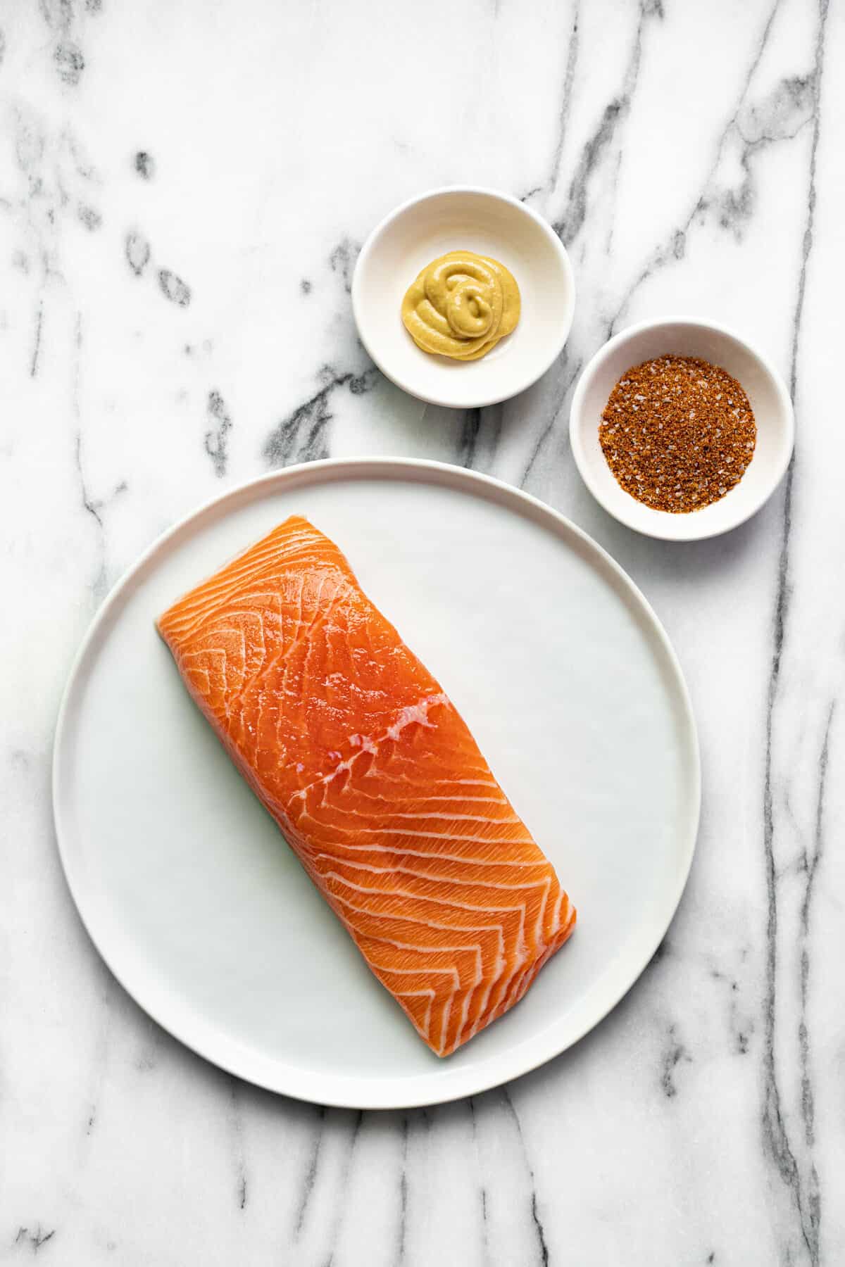 White marble counter top with ingredients to make smoked salmon.