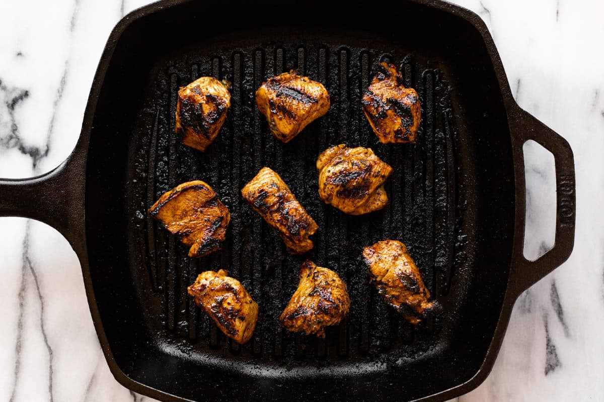Cast iron grilled with cooked marinated chicken breast.