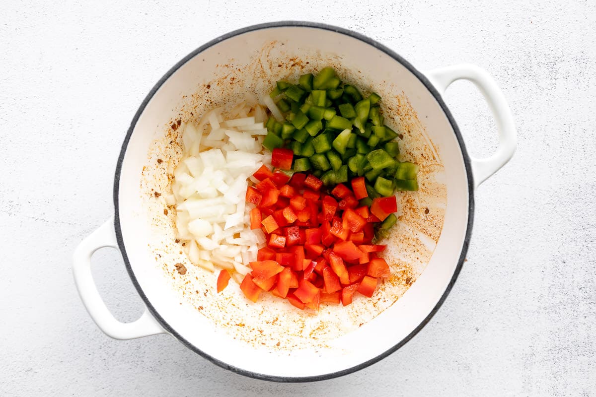 Diced veggies in a large white pot.