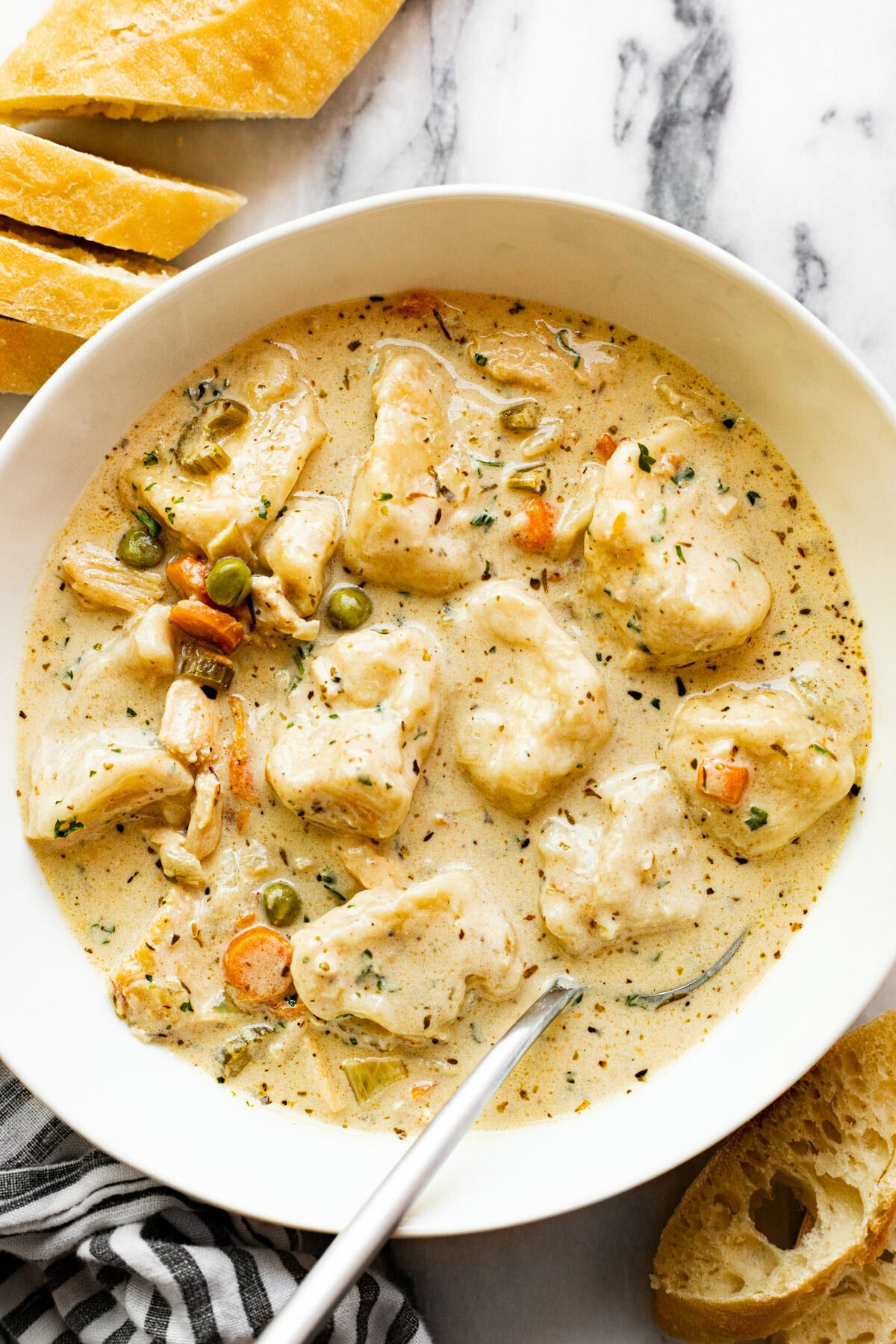 White bowl filled with homemade chicken dumpling soup.