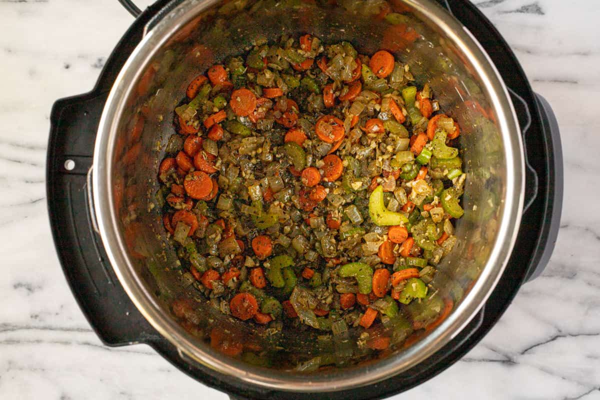 Veggies and herbs sauteed in an instant pot.