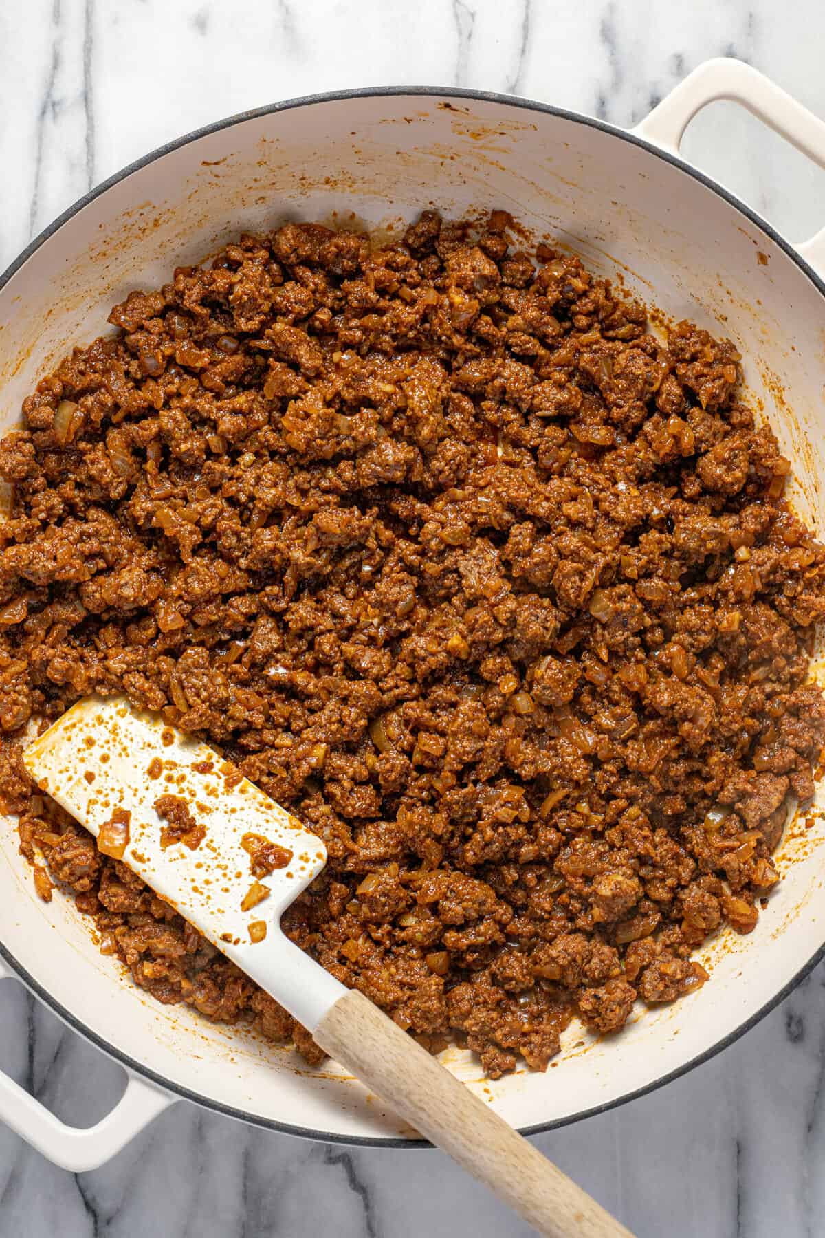 Large white sauté pan filled with homemade taco meat.