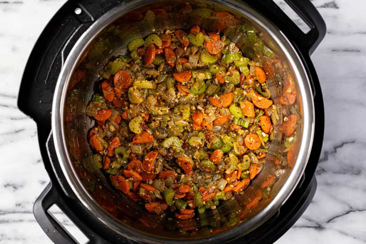 Instant pot filled with sauteed veggies.
