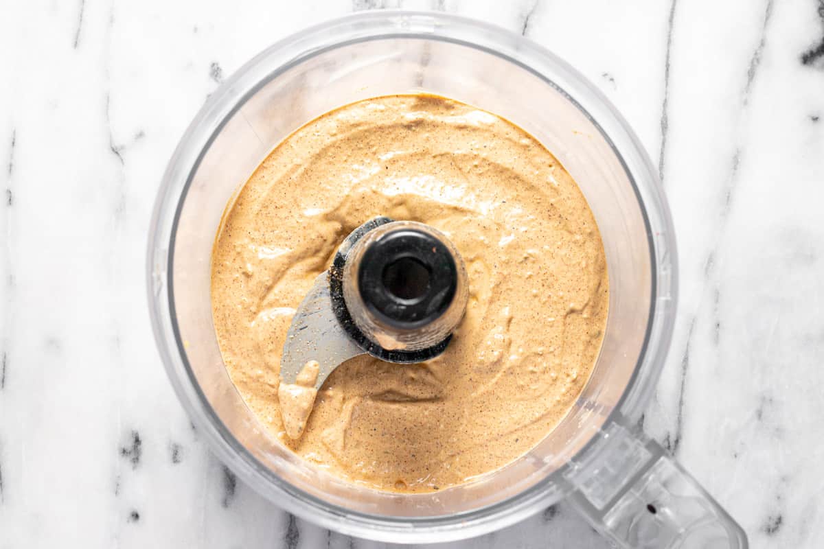 Food processor filled with creamy jalapeno sauce for quesadillas.