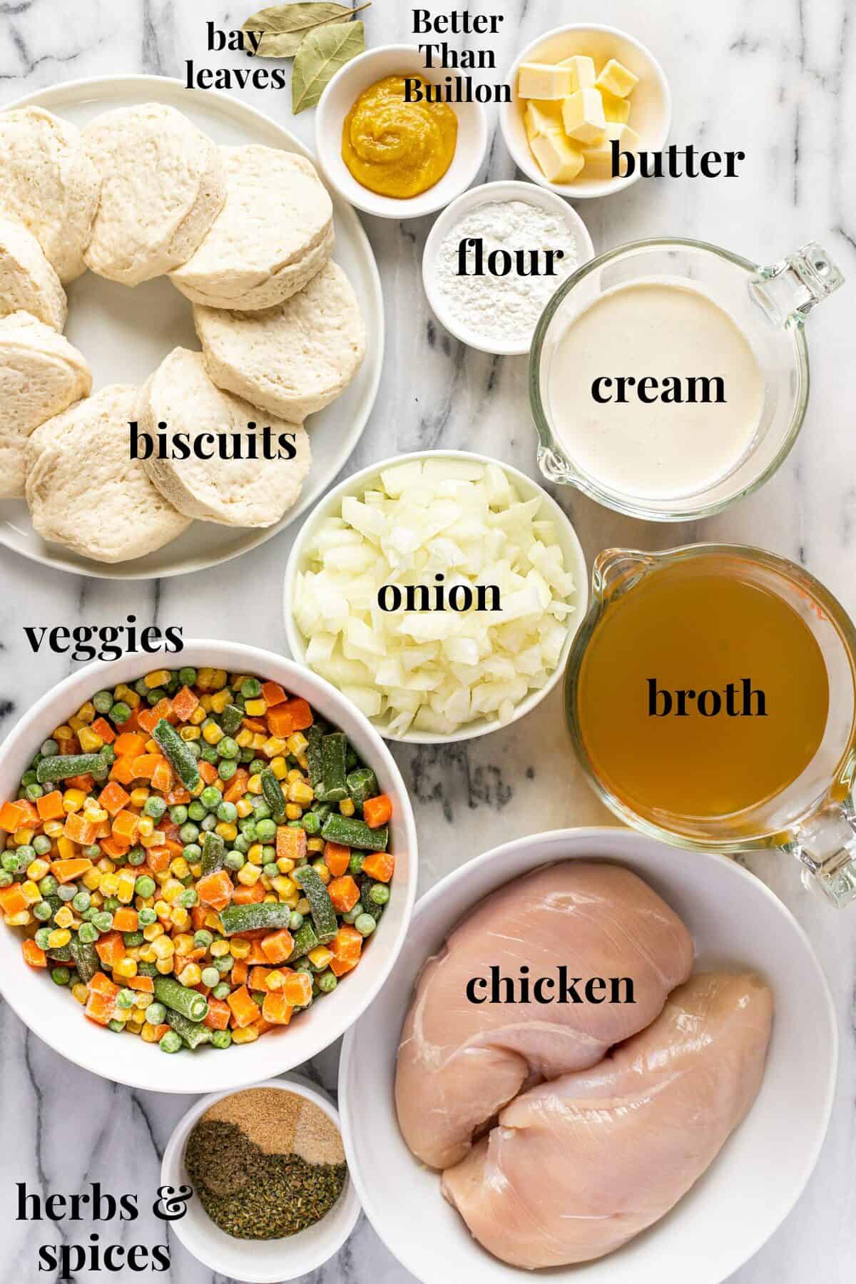 White marble counter top with bowls of ingredients to make slow cooker chicken pot pie.