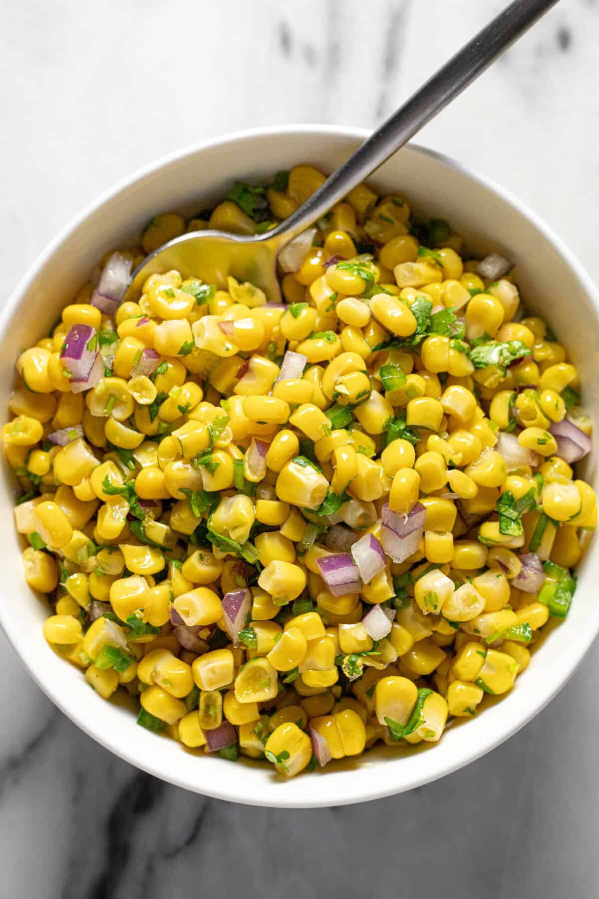 White bowl filled with homemade Chipotle corn salsa.