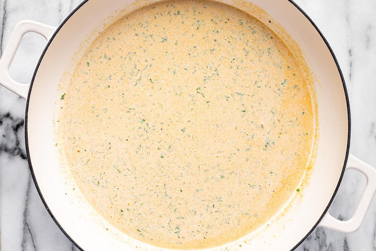 Creamy Cajun pasta sauce in a large white pan.
