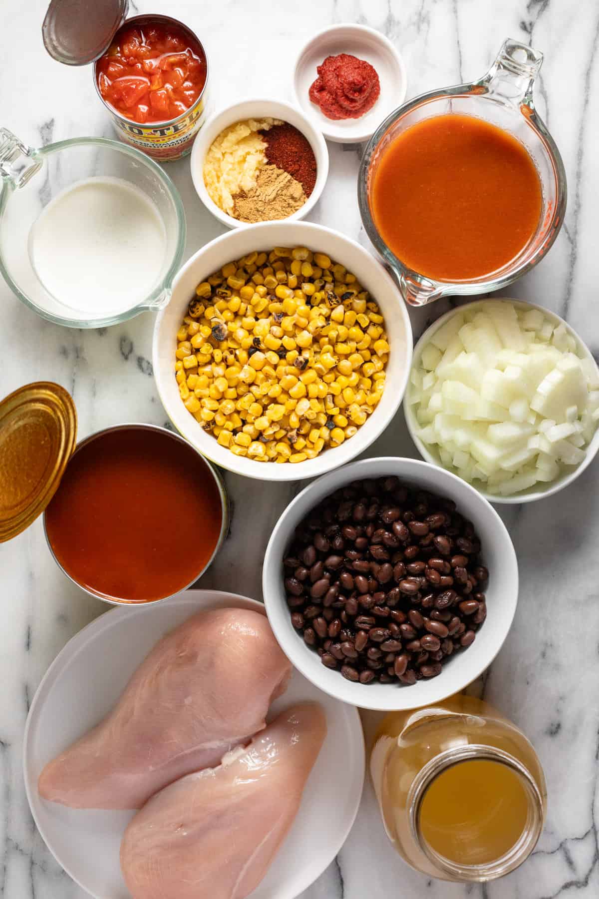 Bowls of ingredients to make creamy chicken enchilada soup.