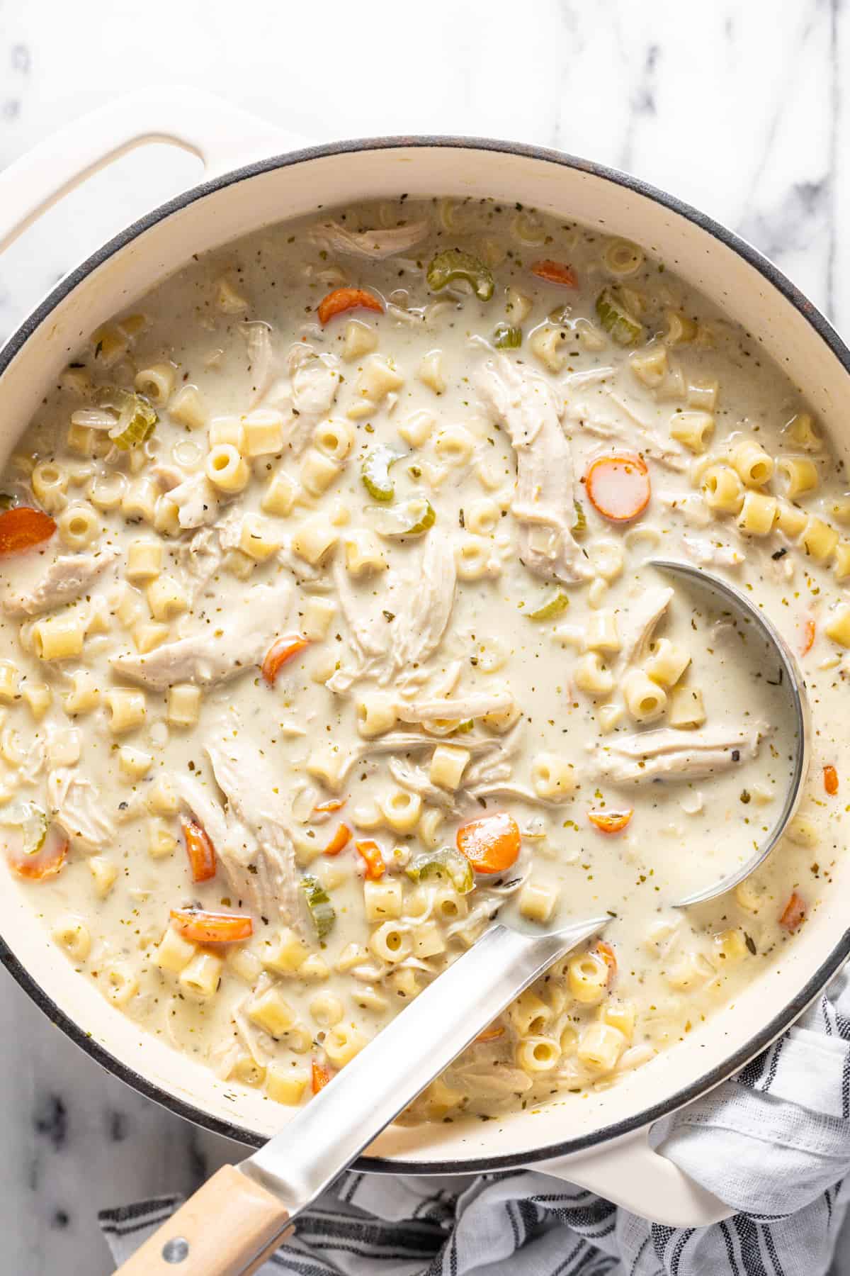 Large pot filled with creamy homemade chicken noodle soup.