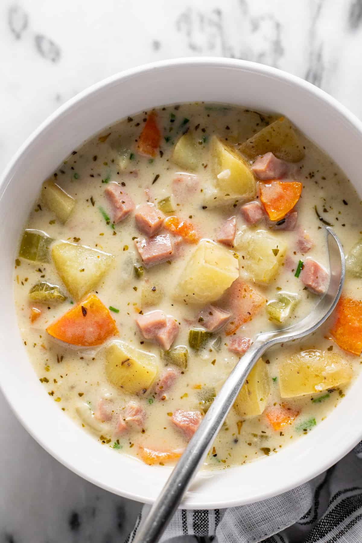 Bowl filled with creamy homemade ham and potato soup.