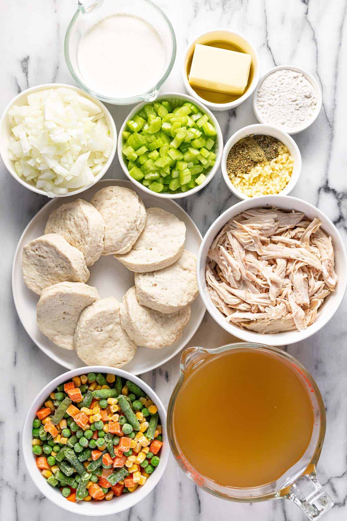 Bowls filled with ingredients to make chicken pot pie soup. 