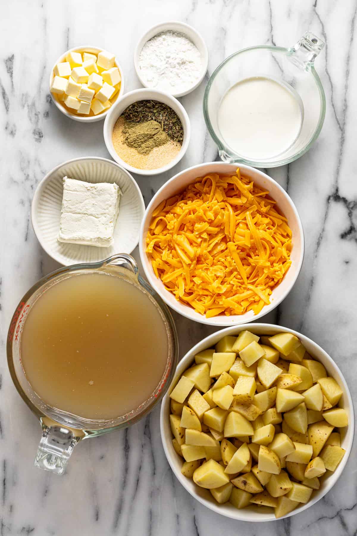 Bowls of ingredients to make homemade creamy crock pot potato soup. 
