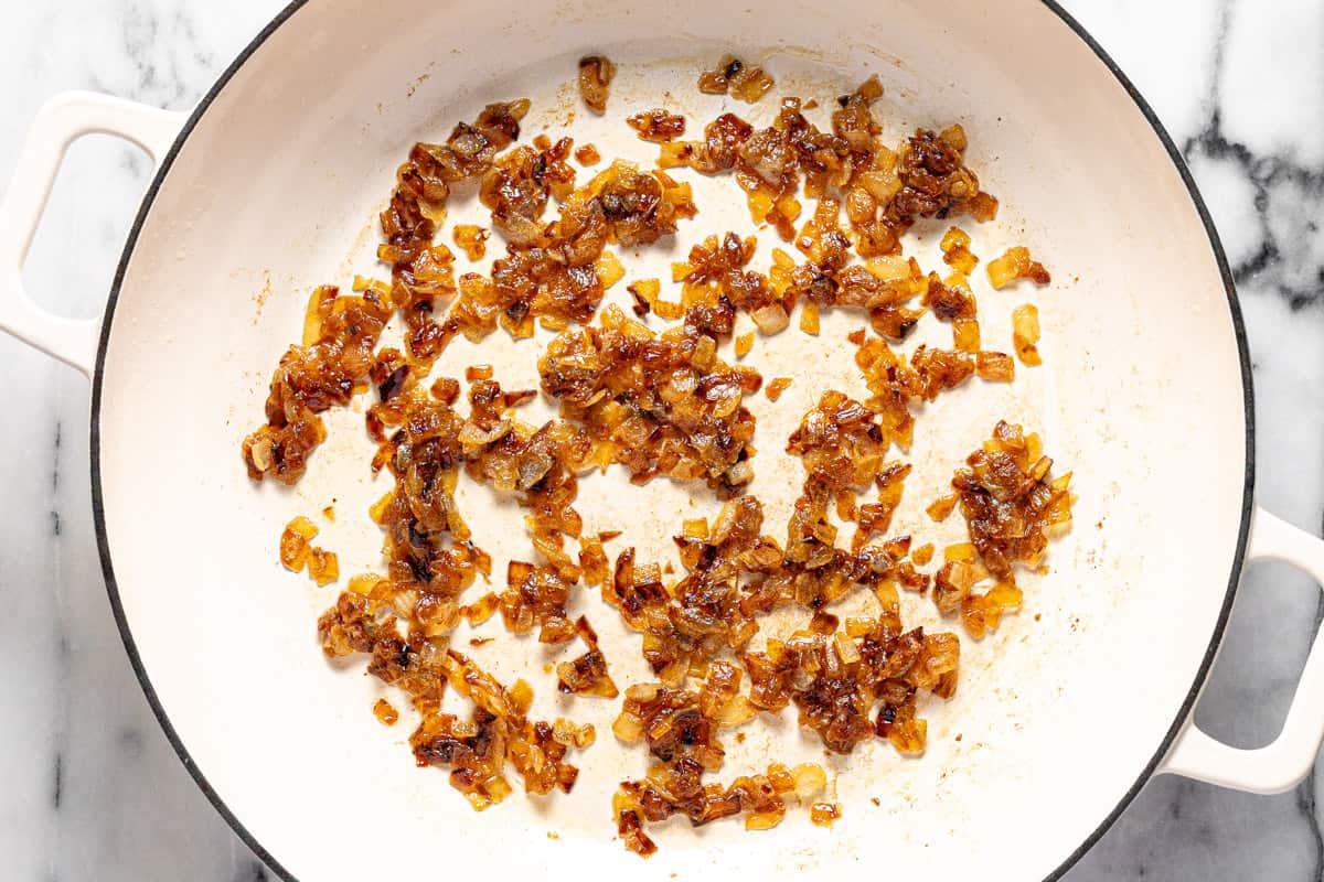 Caramelized diced onion in a large pan.