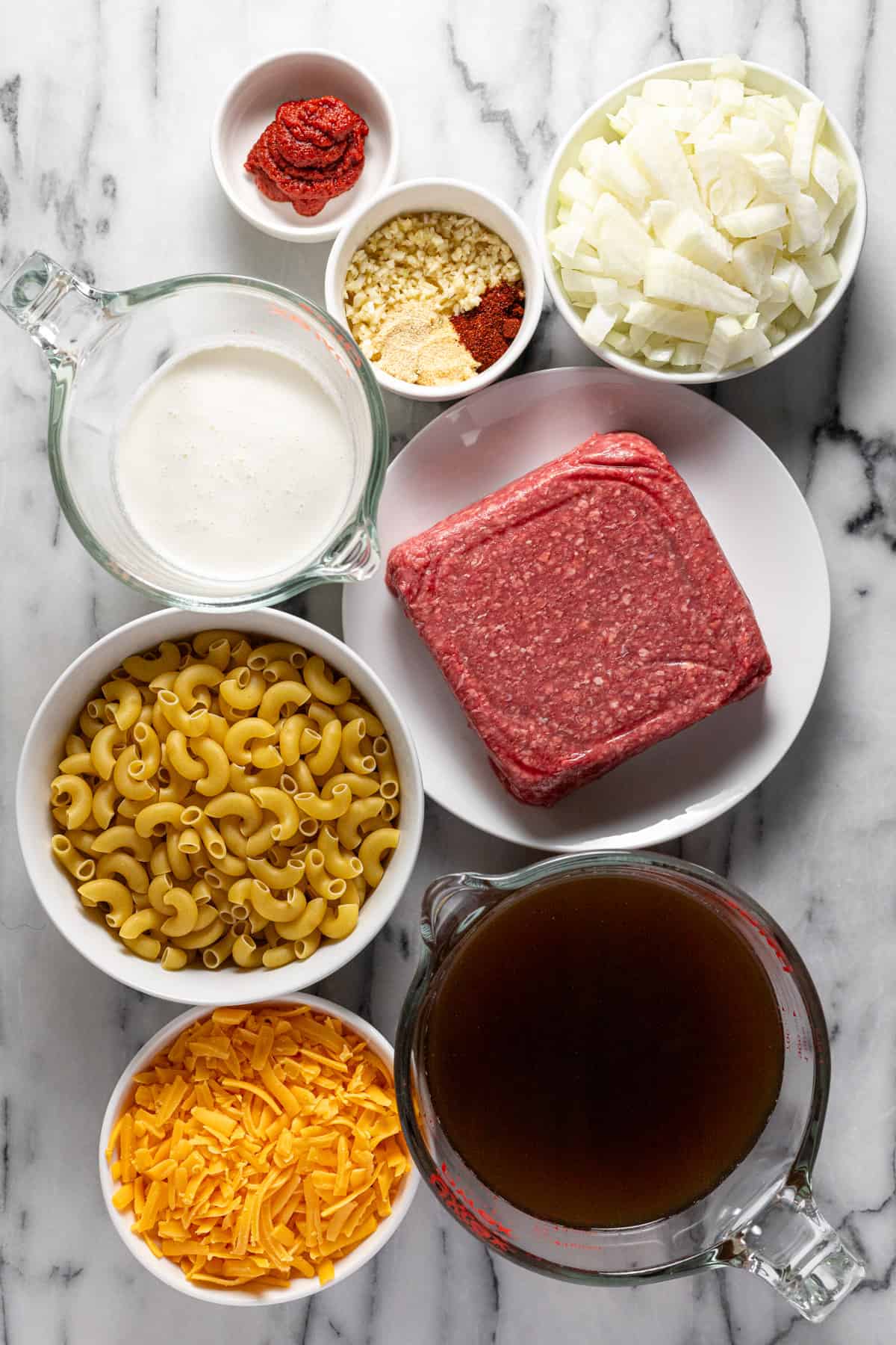 Bowls of ingredients to make hamburger helper at home.