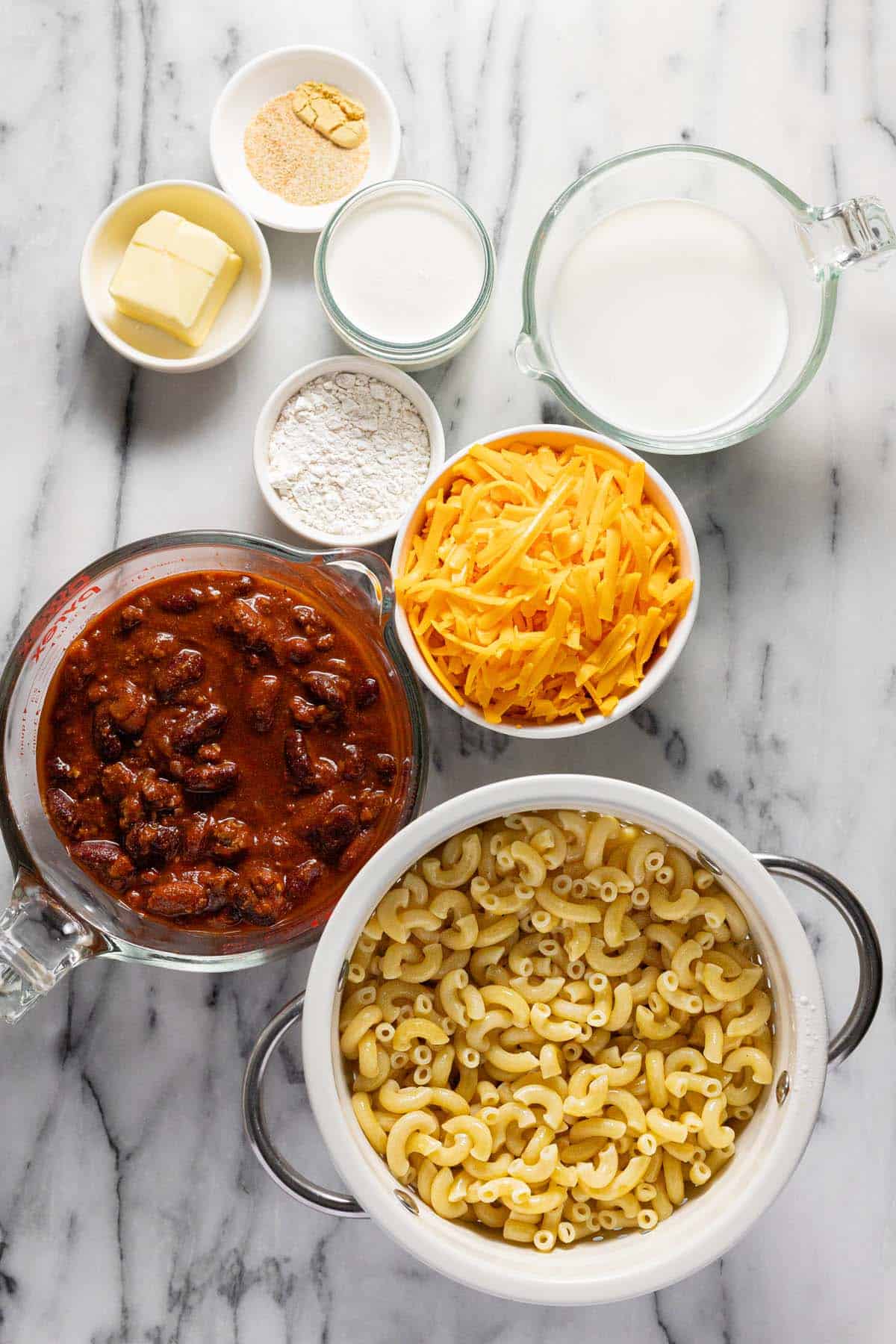 Bowls of ingredients to make chili mac. 