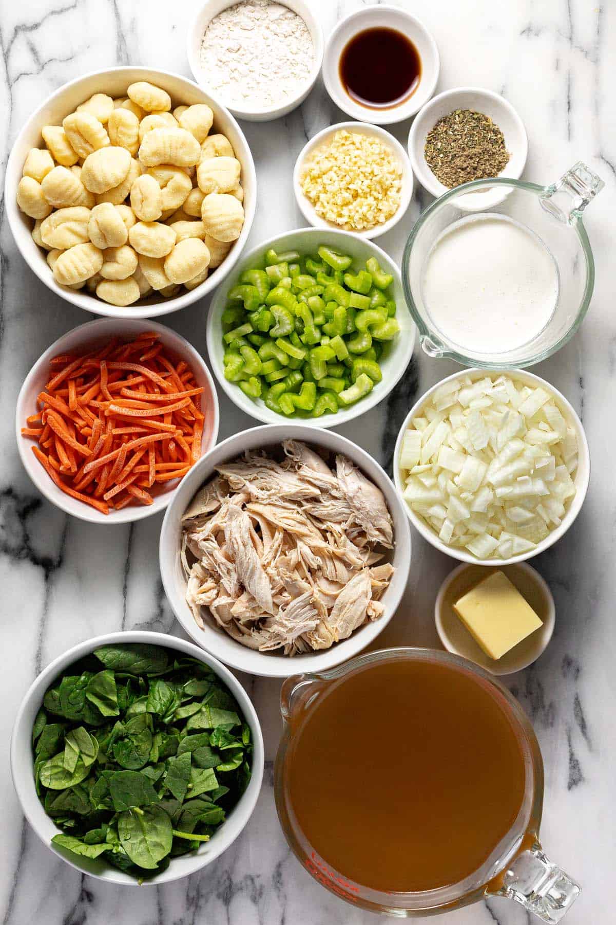 Bowls of ingredients to make copycat Olive Garden chicken gnocchi soup. 