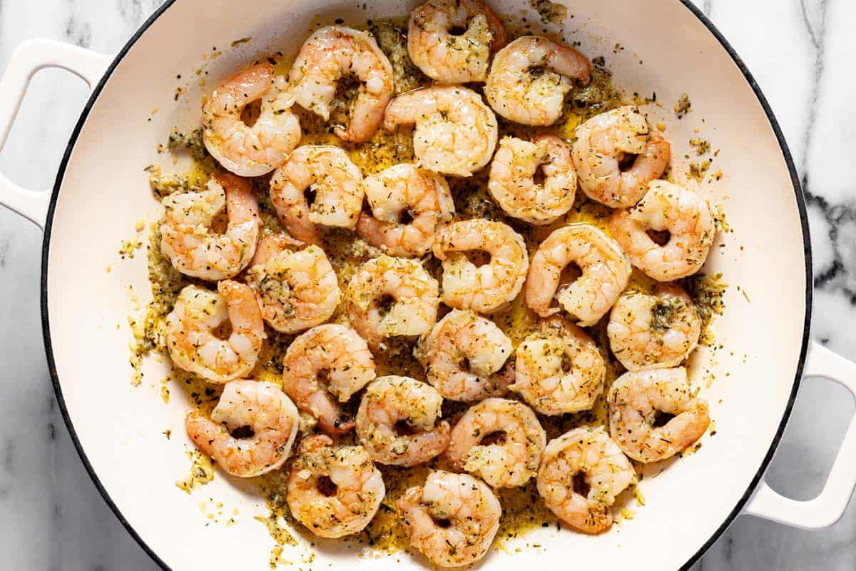 Large pan filled with shrimp sauteed in butter and garlic. 