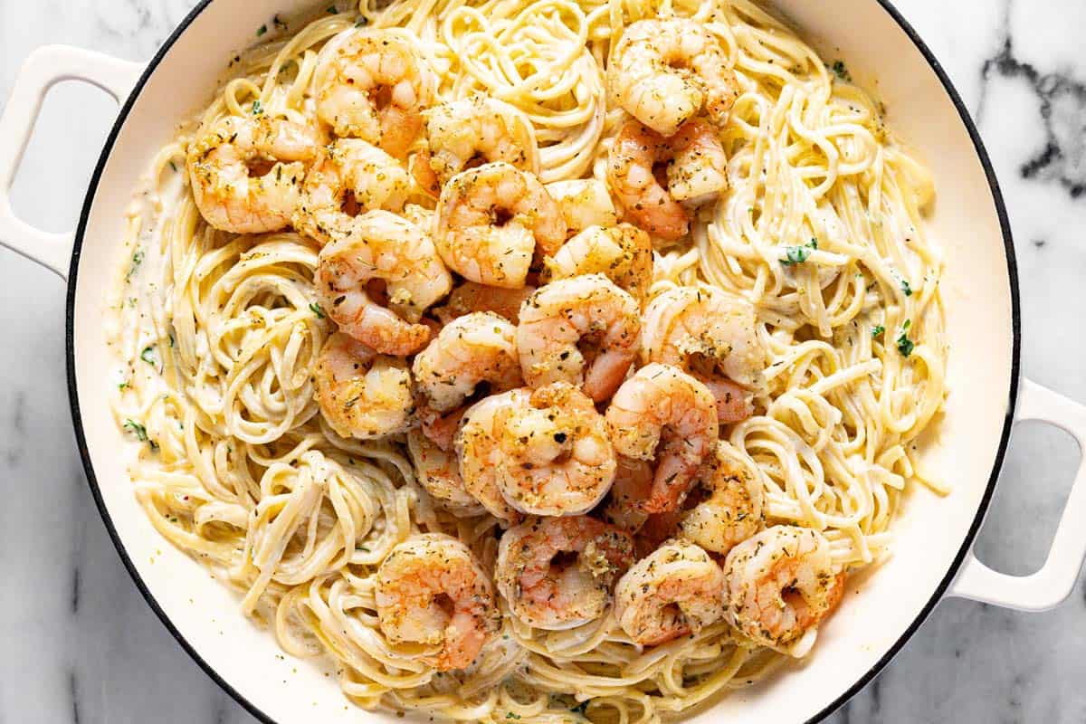A large pan of creamy homemade shrimp pasta. 