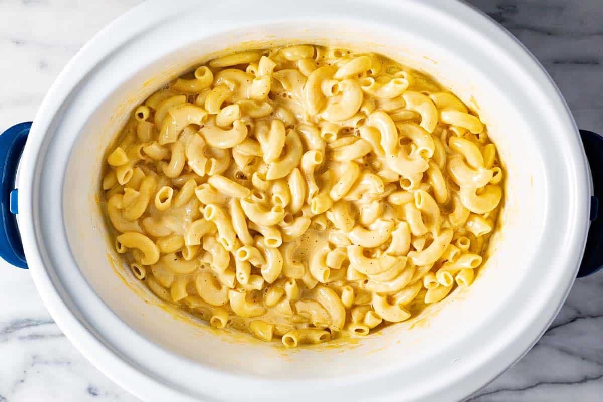 A large crock pot filled with creamy homemade slow cooker mac and cheese. 